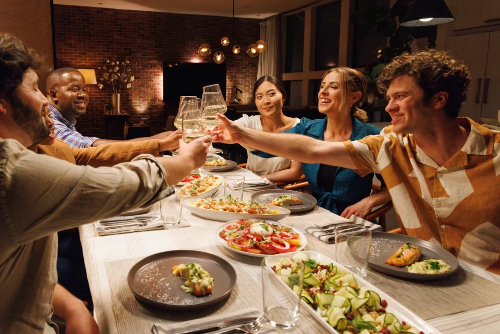 Friends toasting over dinner in a warmly lit restaurant scene