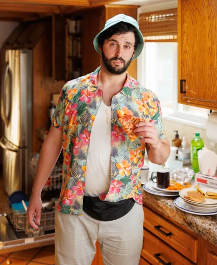 An actor in a loud shirt on the set of a comedic advertisement