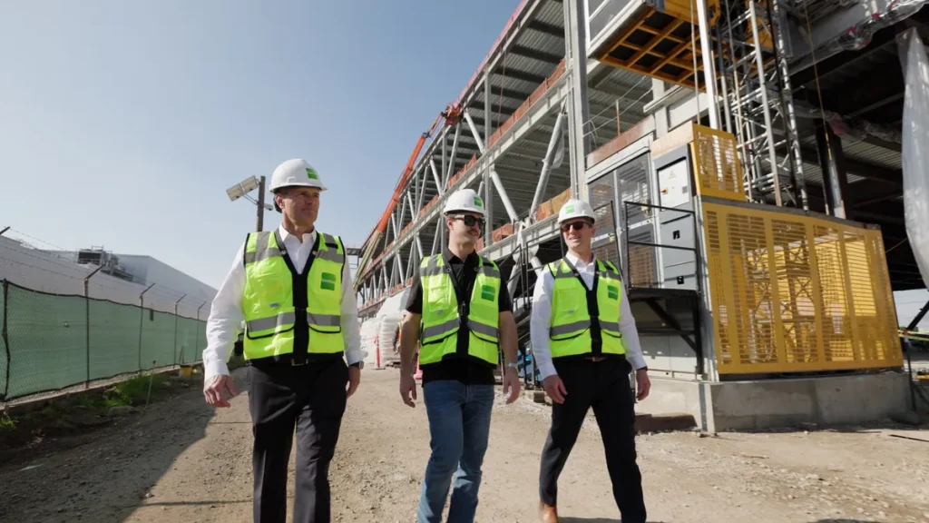A team in hi-vis vests walking past a building under construction