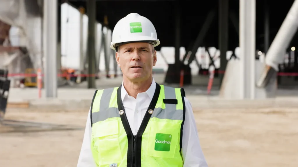 An executive in a hard hat walking a construction site